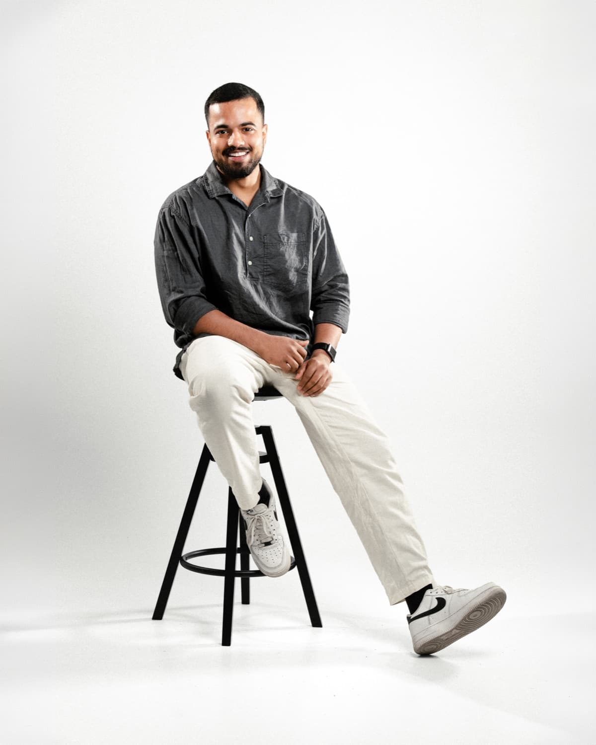 Mohammed, full-stack developer, sitting on a stool